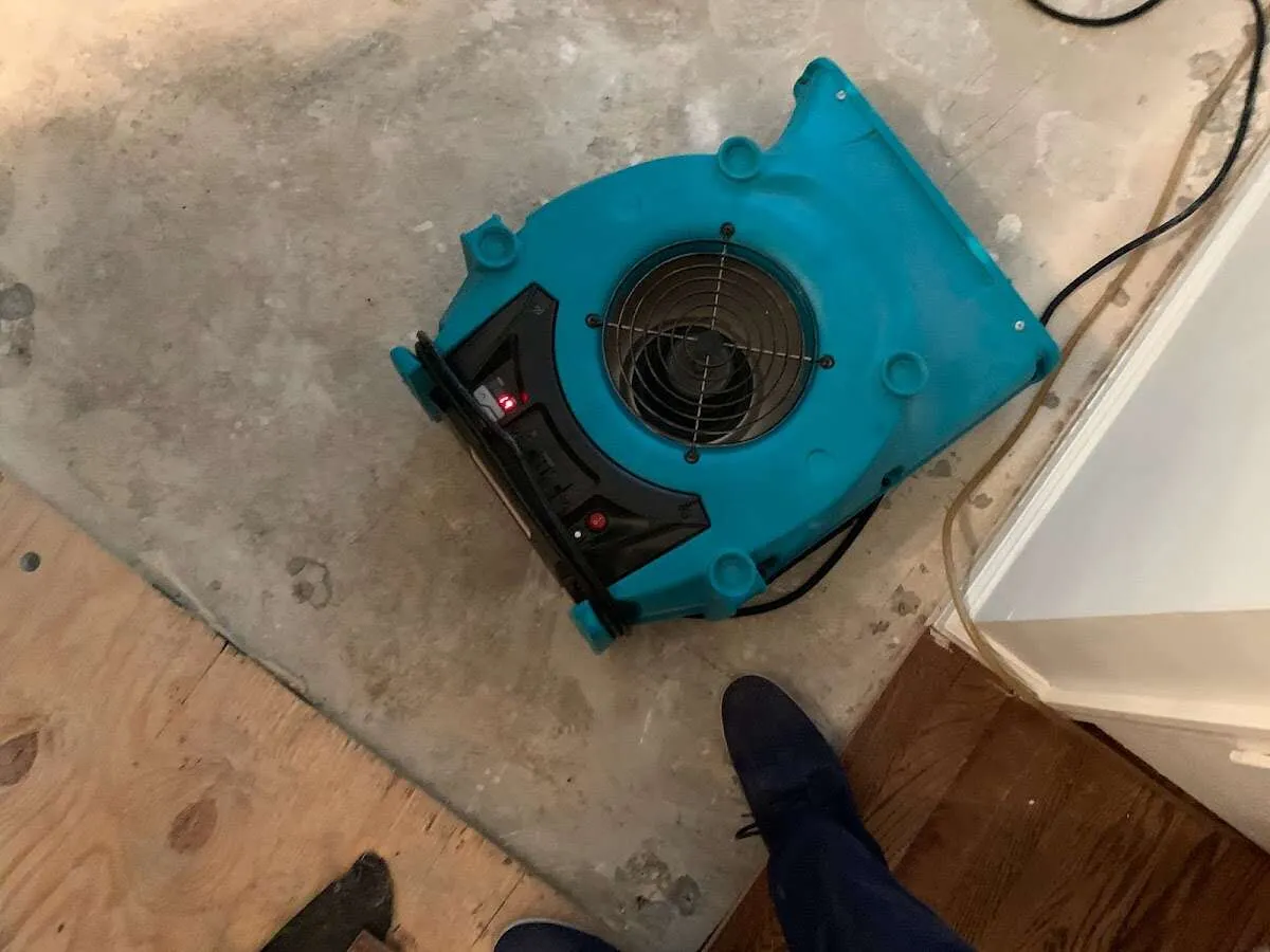 Air mover drying subfloor during Commercial Water Damage Restoration in The Pinery
